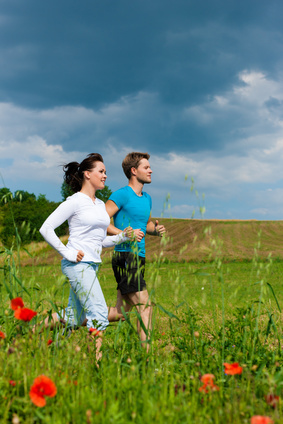 Couple jogging poppy field